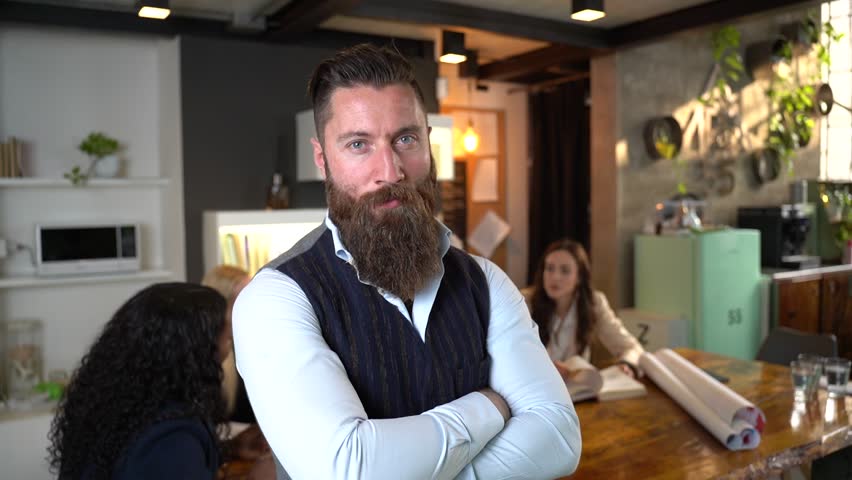 Confident businessman nodding with self assurance in slow motion office portrait. From serious to proud with subtle smile. Concept of leadership, trust, power and masculine success in business.