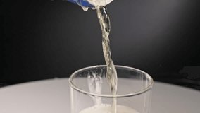 Super slow motion close-up of beer, alcohol, and carbonated drink beverage and ale brew pouring and spilling into a glass and over pouring out of container, with bubbles and carbonation in a studio 4k - Powered by Shutterstock - Get 15% off with code: PIKWIZARD15