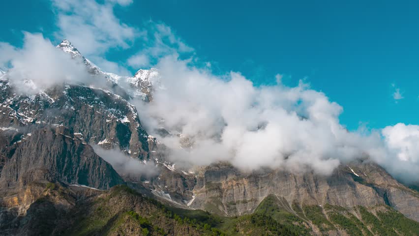 4K timelapse of monsoon clouds rolling above Himalaya mountain peaks during monsoon season at Lahaul, Himachal Pradesh, India. Travel and holidays concept. Nature background. 