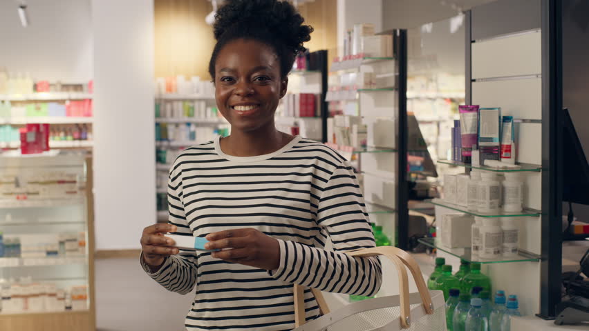 African American woman buying medicine drugs vitamins health care supplements in pharmacy healthy female portrait customer shopping medication pills antibiotic dosage chronic disease remedy products
