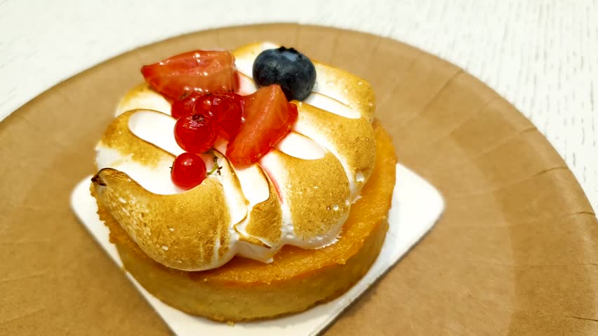 Lemon tartlet with burnt meringue. Fruit tartlet dessert.