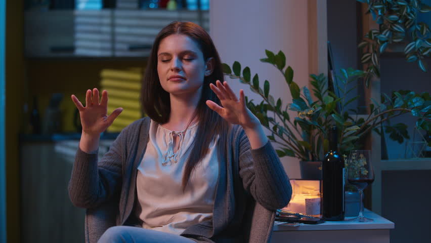 Caucasian woman meditate alone at night evening home practice breathing meditation close eyes stress relief calm serene girl female calmness tranquil relax meditate health mind relaxation deep breathe