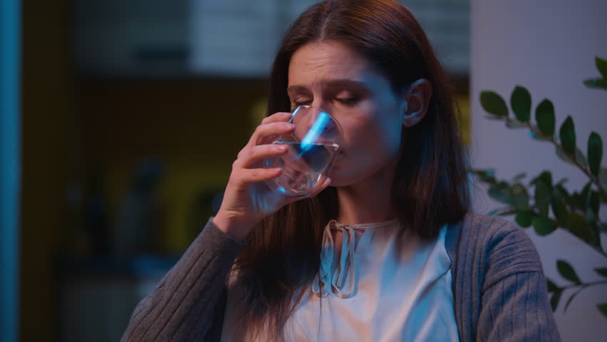 Woman healthy girl drinking glass of water thirst at home night evening apartment Caucasian female housewife drink fresh beverage thirsty slimming diet health care refreshing aqua balance nutrition