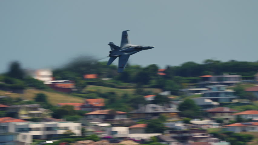 Military fighter jet flying low over green landscape, real sound recorded