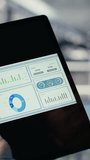 Vertical video Close up of data center employee checking infrastructure diagnostics graphs on tablet screen. IT specialist on industrial platform in server room examining data charts during system - Powered by Shutterstock - Get 15% off with code: PIKWIZARD15