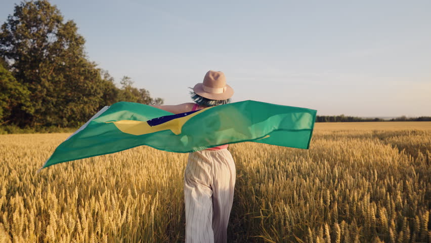Brazilian Woman Running Through Wheat Field Holding National Flag, Football Fan