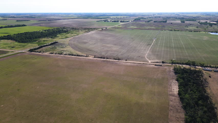 Drone shot approaching a swath, an area of ruined crop, tornado aftermath in USA