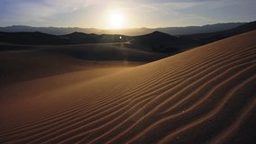 Golden hour light casting soft shadows over the sand dunes of Death Valley, highlighting the vastness and beauty of the desert landscape with rippling sand patterns - Powered by Shutterstock - Get 15% off with code: PIKWIZARD15