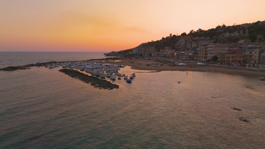 Serene sunset over Marina di Palma, Sicilia with boats and calm sea