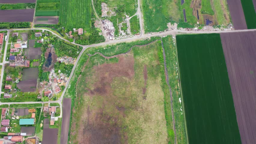 Aerial view of farmland and rural development in a lush green landscape
