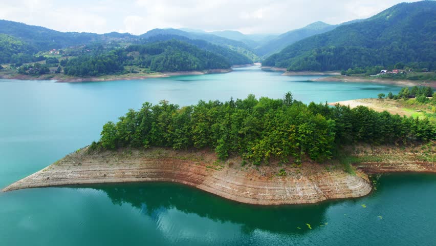 Explore the beauty of Lake Zaovine in Tara National Park, Serbia during a serene summer day