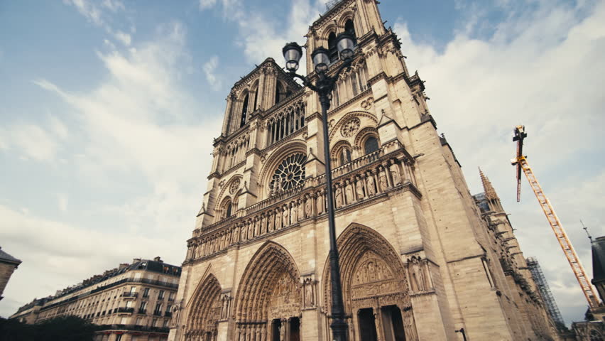 Notre Dame de Paris in the capital of France. Beautiful architecture of the ancient cathedral in the tourist streets of the European city.