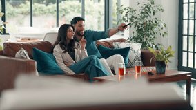 Couple, remote and watching tv with pointing on sofa for movie choice, bonding and search show. Hug, happy people and conversation in house for film subscription, weekend break and streaming service - Powered by Shutterstock - Get 15% off with code: PIKWIZARD15