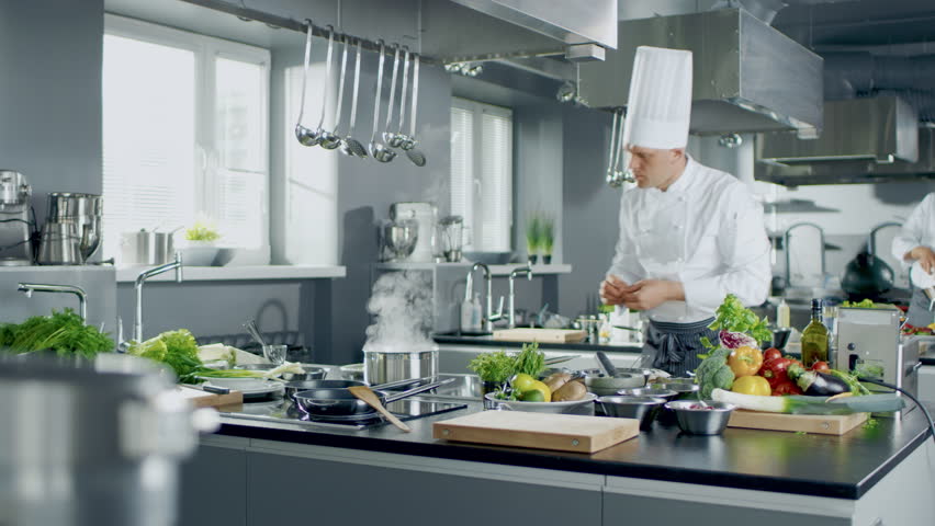 Chefs in White Uniforms Prepare Fresh Vegetables and Cook Meals in a Modern Restaurant Kitchen. Various Ingredients, Utensils, Team Works to Create Healthy Dishes.