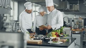 Three White Chefs collaborate in a Modern Kitchen, Using a Digital Tablet to Browse Online Menus and Order Fresh Ingredients, Culinary Creativity With Innovative Ecommerce Technology for Meal Planning - Powered by Shutterstock - Get 15% off with code: PIKWIZARD15