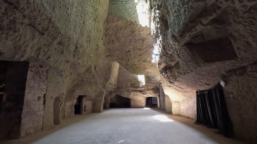 Tilt to skylight in underground tufa cave cellars of Maison Ackerman