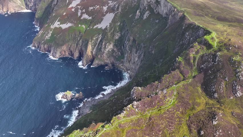 Slieve League mountain peak over the cliffs. Beautiful scenery of Donegal, Ireland. Drone reveal