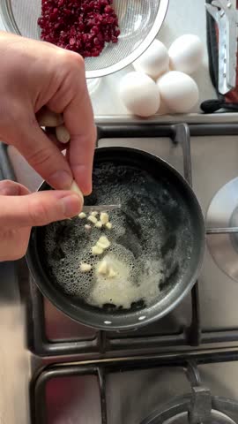 cooking tasty Omelet in butter ghee frying pan add egg to garlic in oven stove kitchen Persian breakfast pancake food lifestyle of local marinade recipe in Tehran brisket beef in traditional village