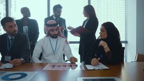 Diverse team of professionals gathers around a laptop, collaborating on a project in a modern office setting, showcasing teamwork and innovation - Powered by Shutterstock - Get 15% off with code: PIKWIZARD15