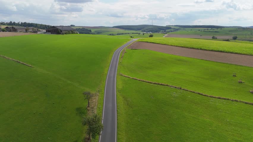 Road through nature in Luxembourg, landscape aerial view, summer meadow, field and forest, travel countryside, agriculture