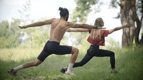Couple Doing Yoga Warrior Pose. Man And Woman Exercising Together. Partner Fitness Workout. Yoga Pilates. Physical Wellness Outdoor Yoga Session. Body Strength Strong Core. Fitness Abdominal Exercise - Powered by Shutterstock - Get 15% off with code: PIKWIZARD15
