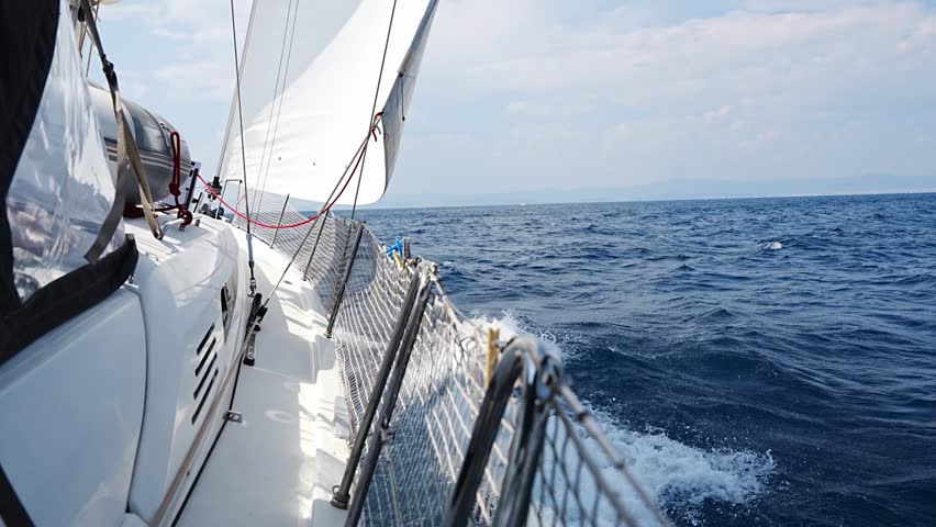 Side of a sailing yacht cutting through the sea with full sails near Croatia. Motion, freedom, sailing lifestyle and adventure on the open water. High quality 4k footage