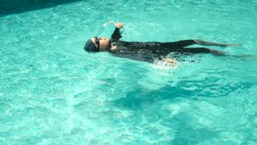 Relax moment of man in swim cap and rash guard adjusts their swimming goggles ready to dive into the pool. Aquatic sports and a healthy active lifestyle perfect fitness and summer activities. - Powered by Shutterstock - Get 15% off with code: PIKWIZARD15