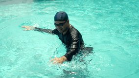 Relax moment of man in swim cap and rash guard adjusts their swimming goggles ready to dive into the pool. Aquatic sports and a healthy active lifestyle perfect fitness and summer activities. - Powered by Shutterstock - Get 15% off with code: PIKWIZARD15