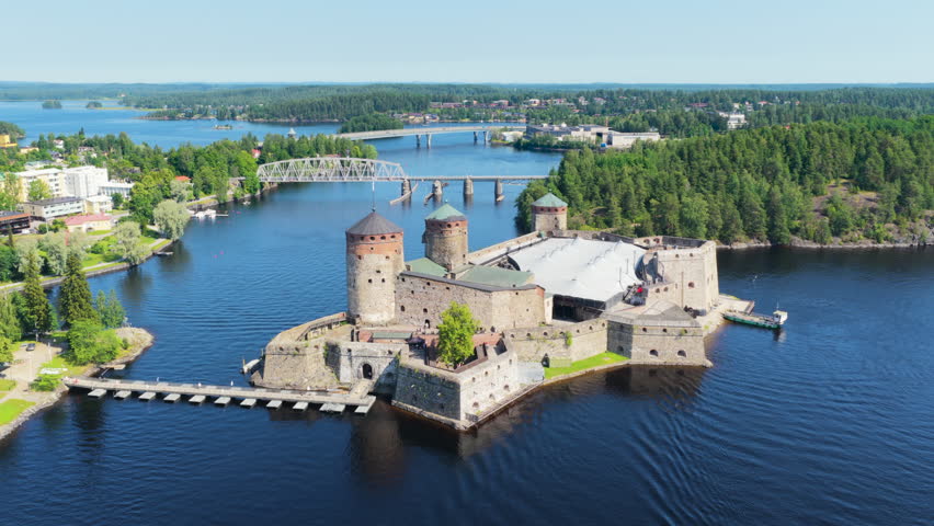 Aerial view circling the Olavinlinna castle, sunny, summer day in Savo, Finland