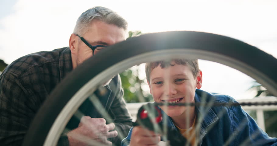Bicycle, smile or wheel with father and son outdoor in backyard for fixing or maintenance. Equipment, gears and turning tyre with single parent man teaching boy child how to repair bike on patio