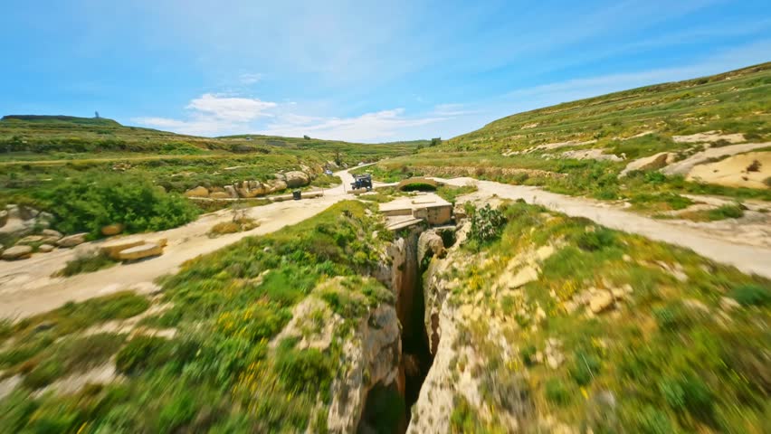 Flight over famous natural arch on Gozo island, Malta island
