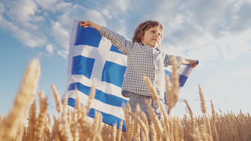 Patriot Boy Standing Wheat Field Holding Greek Hellas Flag in the Wind, Homeland