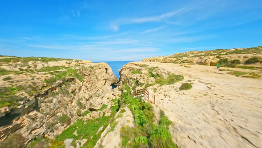 FPV drone flight in natural arch on Gozo island, Malta island