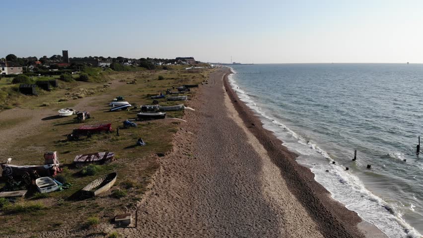 Dog walkers on the Lowestoft Beach on a warm summers morning in Suffolk, UK. 21.06.25