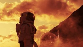 Astronaut Stands on a Dusty Red Planet at Sunset, Observing a Futuristic Geodesic Dome Habitat and Satellite Dish, Red Clouds, Advanced Technology, Exploration, and Future Space Travel. Life on Mars - Powered by Shutterstock - Get 15% off with code: PIKWIZARD15