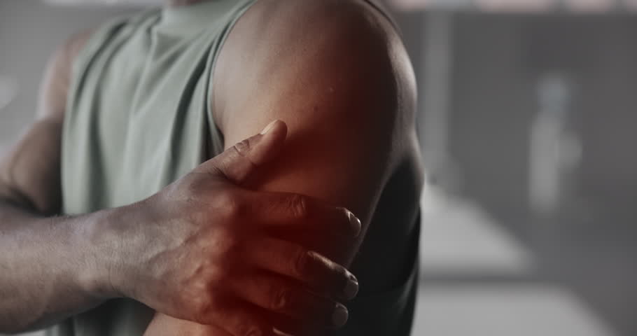 Arm pain, gym and hands of man with accident for workout, training and exercise. Sports, fitness and person with injury, sprain and inflammation with massage for tendinitis, muscle fatigue and strain