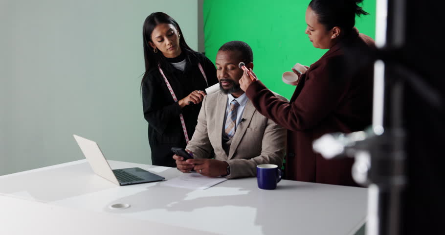 News anchor, makeup and production with man on green screen for broadcast touch up, presenter and help. Journalist reporter, stylist team and talk show host with person in studio for cosmetics