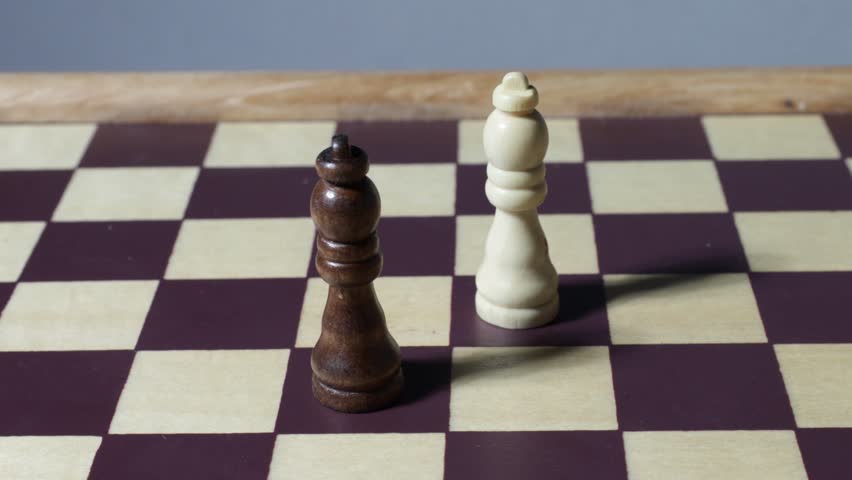 Rotating cinematic shot of queens on a chessboard with shadows.