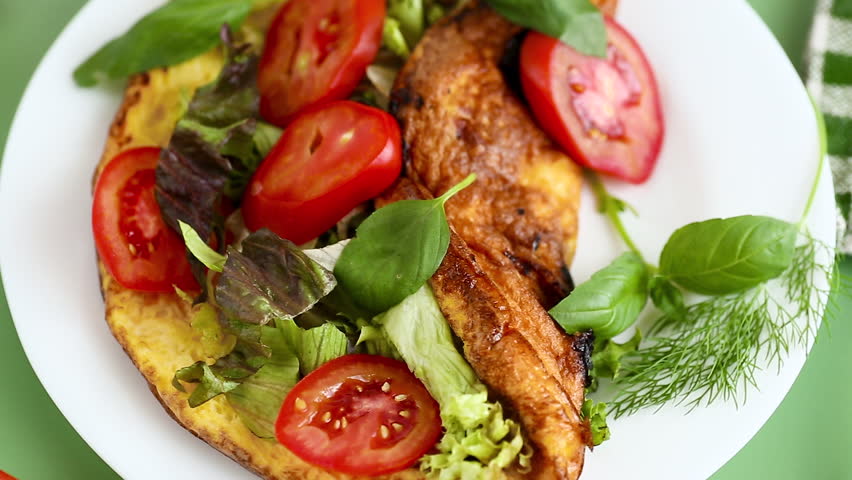 Golden omelette with salad mix and spicy aroma on top