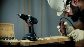 Construction Worker Using Power Tool.  Carpenter In Hard Hat And Safety Glasses. Woodworking Craft DIY Renovation. Skilled Laborer Power Tools. Building And Carpentry. Handyman Tool Use Workshop Tools - Powered by Shutterstock - Get 15% off with code: PIKWIZARD15