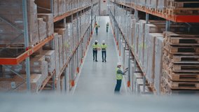 Hardworking warehouse employees wearing safety helmets and vests walking between high pallet racks. Men scanning items with devices. Workers transporting boxes or checking inventory data on tablet. - Powered by Shutterstock - Get 15% off with code: PIKWIZARD15