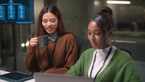 Happy diverse woman colleague and friend laughing with smartphone in modern office. Positive teamwork turns to focused problem solving and data analysis for success - Powered by Shutterstock - Get 15% off with code: PIKWIZARD15