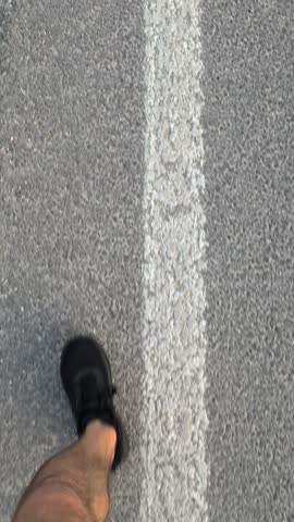 Walking along a Road while wearing Sneakers and enjoying the beautiful scenery around me