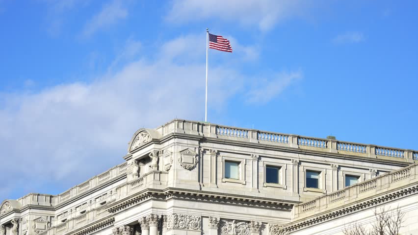 American flag waving in Washington DC. USA symbol. United States flag. Flag against sky in Capitol. Flying American flag. Vote for freedom. Capitol Hill flags