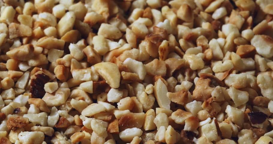 Slow Motion Macro of Chopped Roasted Hazelnuts, Crunchy Nut Pieces Background, Delicious Natural Hazelnut Texture, Organic Nuts For Baking Cooking Dessert Ingredient, Healthy Snack With Nutty Flavor