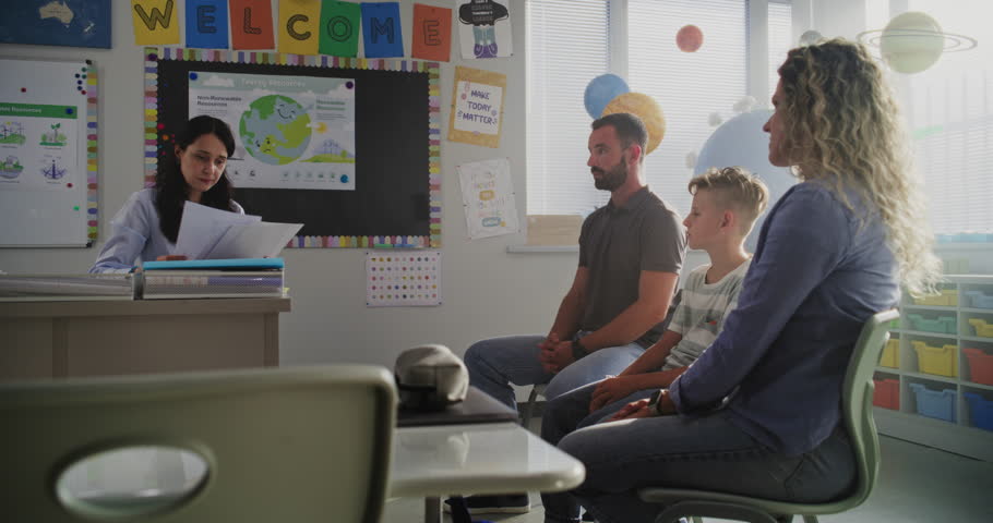 Female Teacher Giving School Exam Results of Young Boy to His Parents. Teacher and Parents Discussing Academic Failure of Primary School Student in Classroom. Meeting to Support Child's Development.