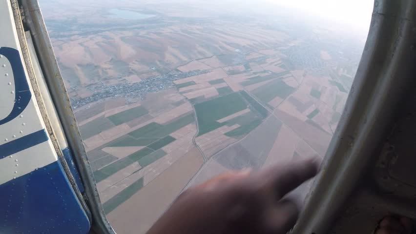 Man jumps out of a plane with a parachute. Point of View. 