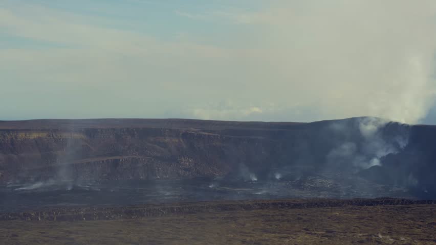 Active Kilauea volcano caldera emitting smoke and steam from Halemaʻumaʻu crater, Hawaiʻi Volcanoes National Park, Big Island