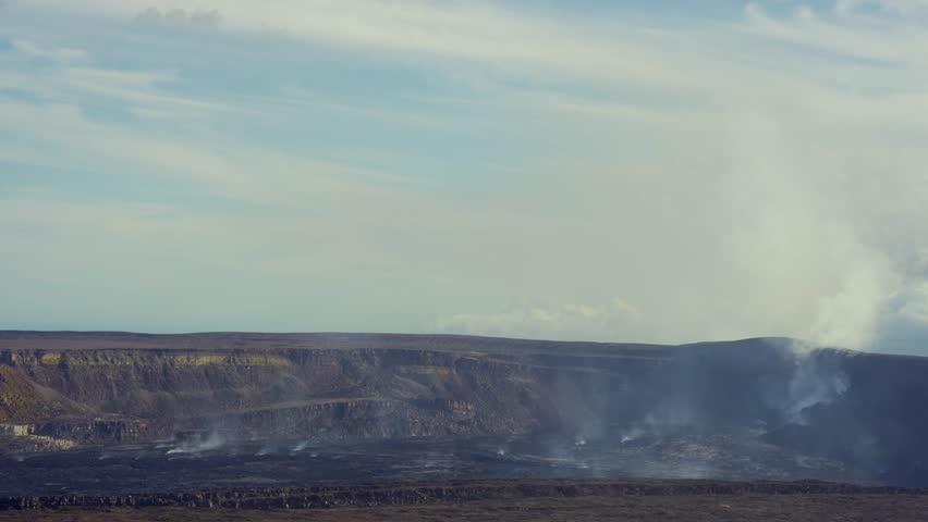 Active Kilauea volcano caldera emitting smoke and steam from Halemaʻumaʻu crater, Hawaiʻi Volcanoes National Park, Big Island