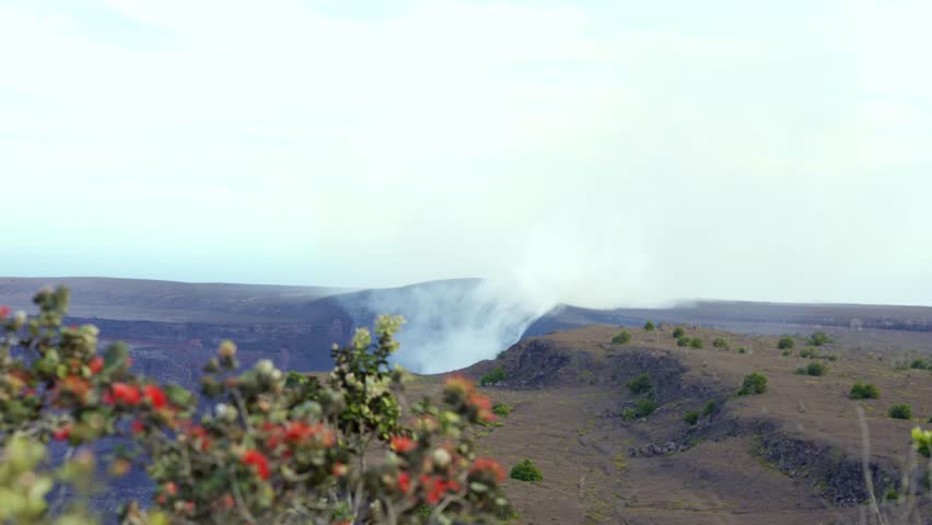 Active Kilauea volcano caldera emitting smoke and steam from Halemaʻumaʻu crater, Hawaiʻi Volcanoes National Park, Big Island